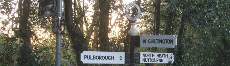 A traditional finger post signpost points the way to Nutbourne, West Sussex